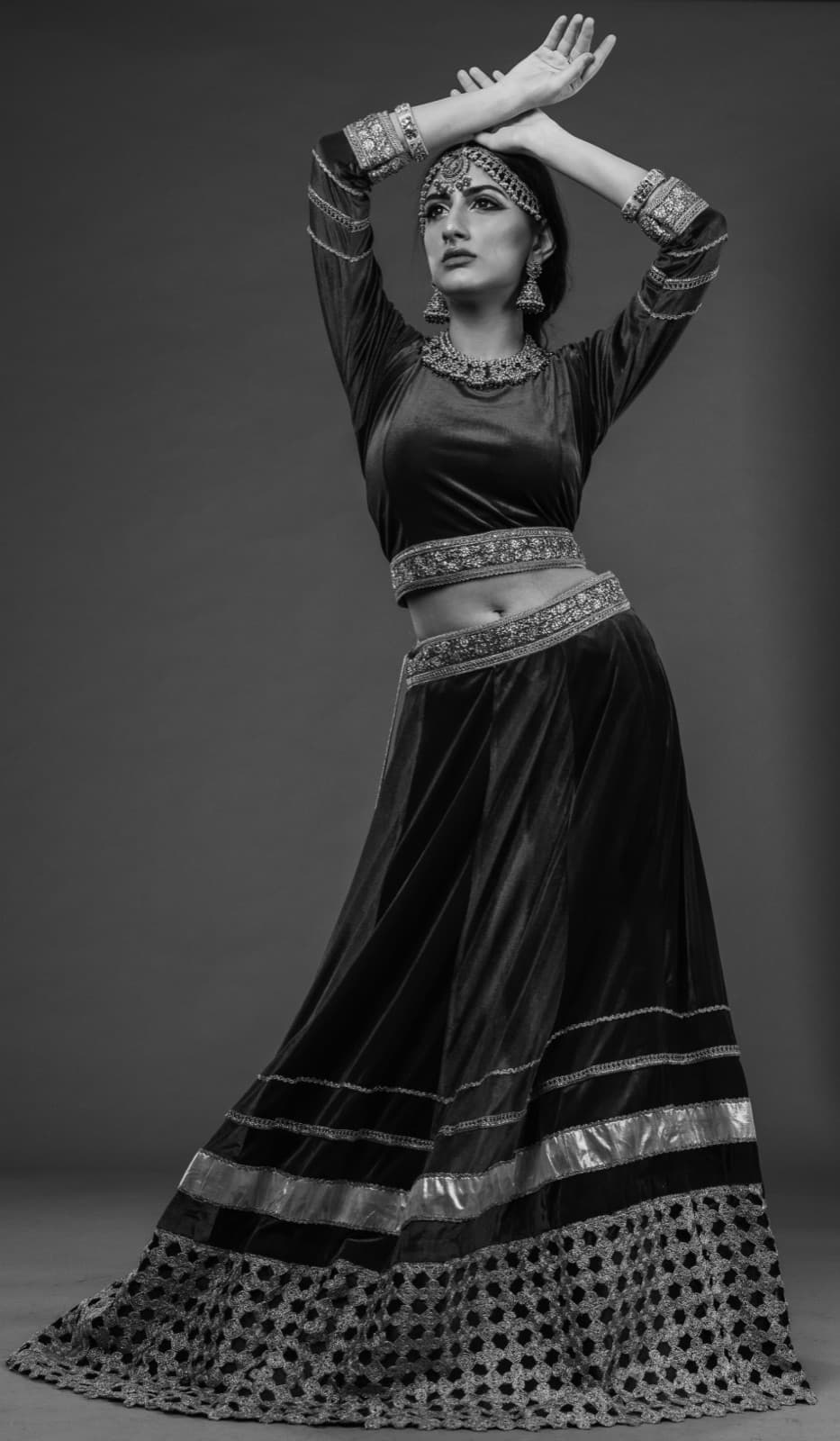 Black and white portrait, arms raised