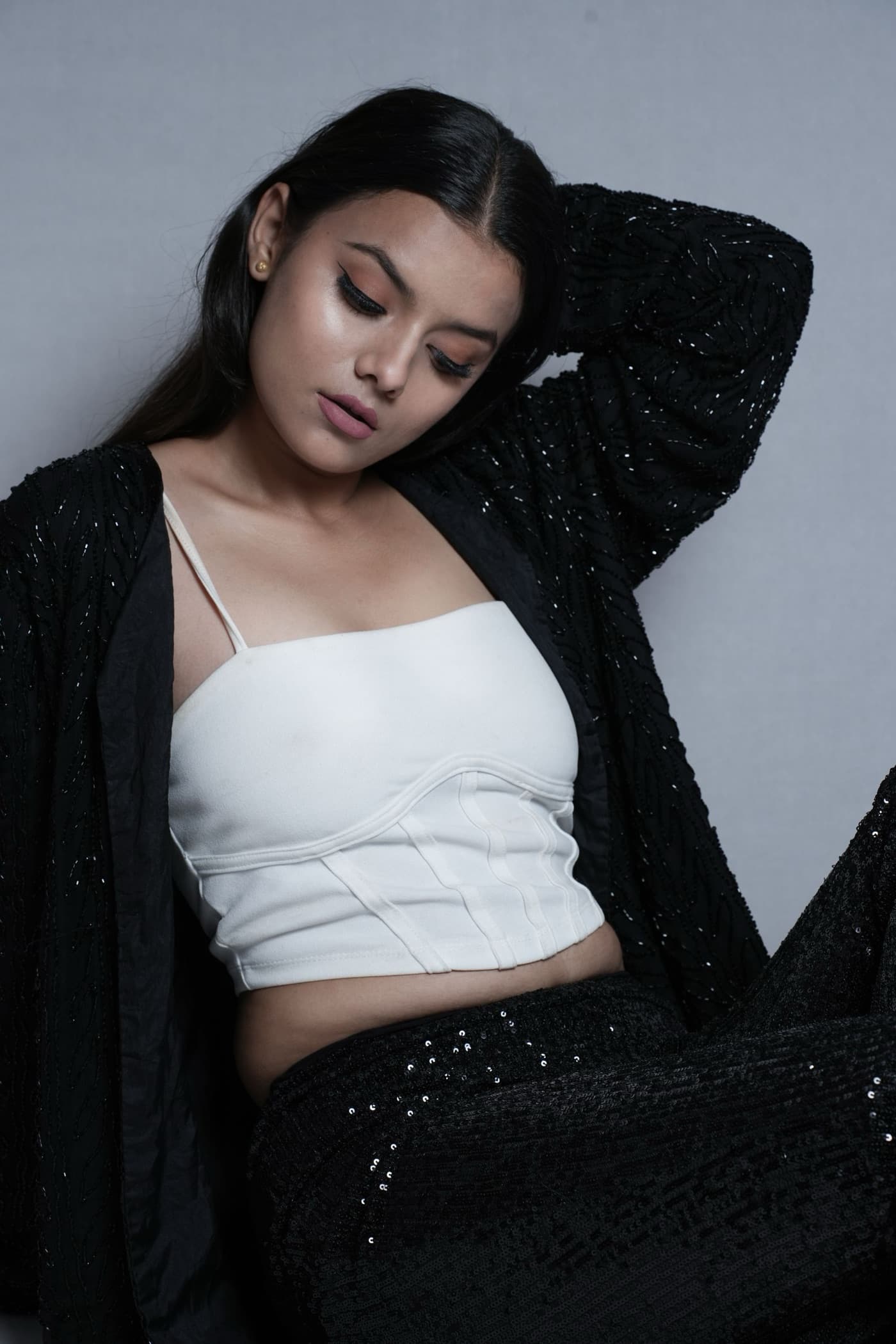 Ishani Rao seated in a black jacket, smiling
