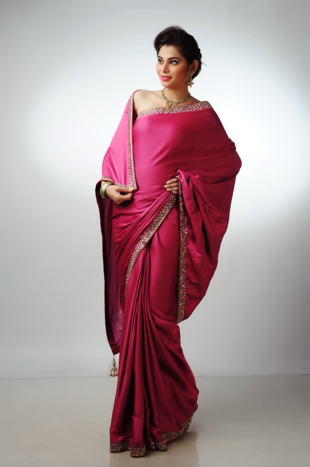 Woman in a pink saree in a studio