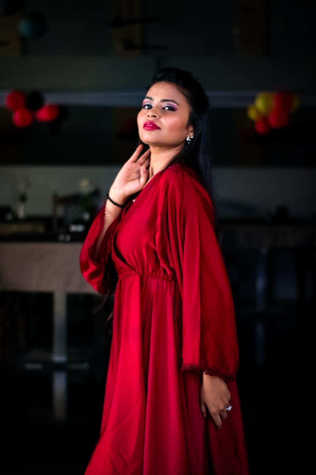 Kavya Iyer in a red robe dress