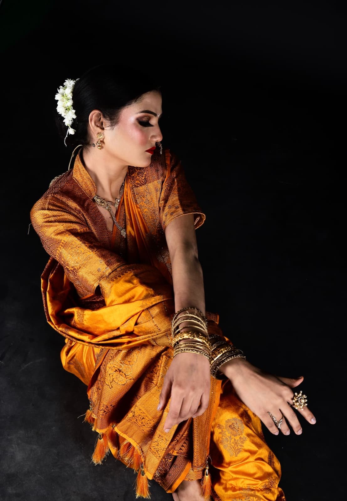 Meera Rathore in gold silk against black