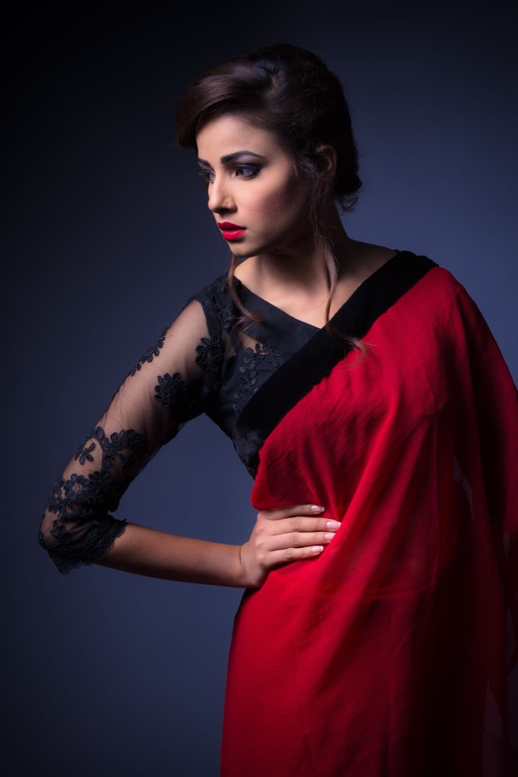 Ritika Sahni in a red saree with a lace blouse