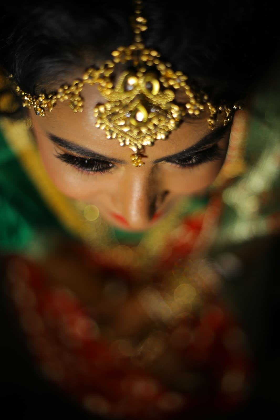 Solo edition sample: woman with a gold maang tikka, eyes lowered